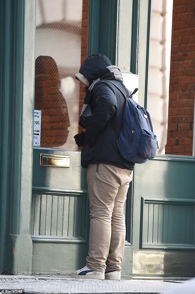 The man was seen looking ambitiously into Swift's Tribeca apartment building on Saturday morning