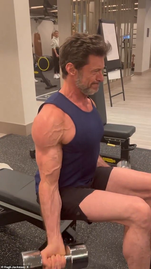 In it, the 55-year-old The Greatest Showman star lifted an impressively heavy set of weights to work his biceps