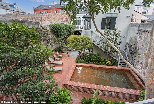 The historic home features many modern features, including an elevator, gym, outdoor pool and fountain