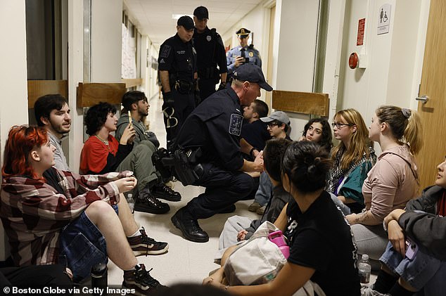 Pictured: Protesters and University of Massachusetts police during the October 25 sit-in