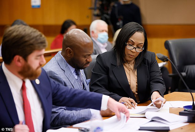 An attorney representing Michael Roman filed the charges against Willis and Nathan Wade (pictured center) and asked for the charges to be dismissed.