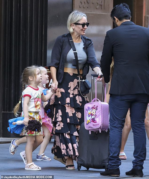 Meanwhile, Fifi, 46, kept her daughters Trixie, eight, and Daisy, two, close as she held her youngest's hand as they loaded their suitcases.