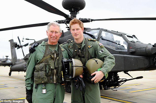 Harry is pictured next to his father in front of an Apache helicopter in March 2011. The Duke joked that he was 