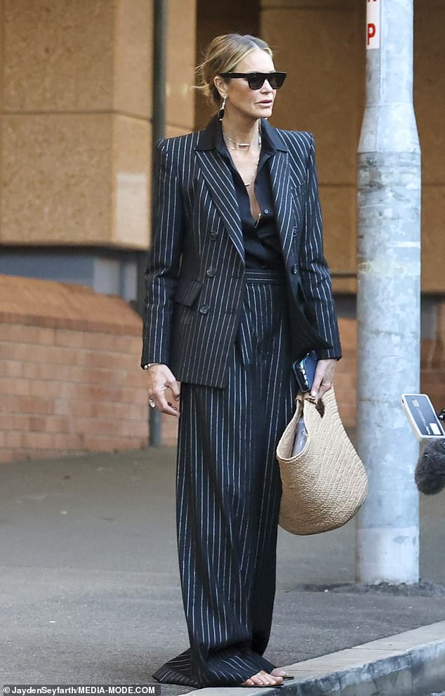 The three-piece, navy blue number was paired with designer flat sandals in a soft brown shade