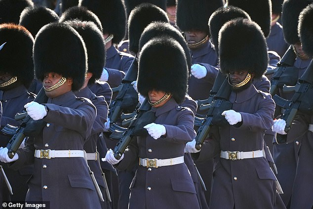 Members of the King's Guard march down The Mall towards Buckingham Palace ahead of the State Opening of Parliament on November 7, 2023