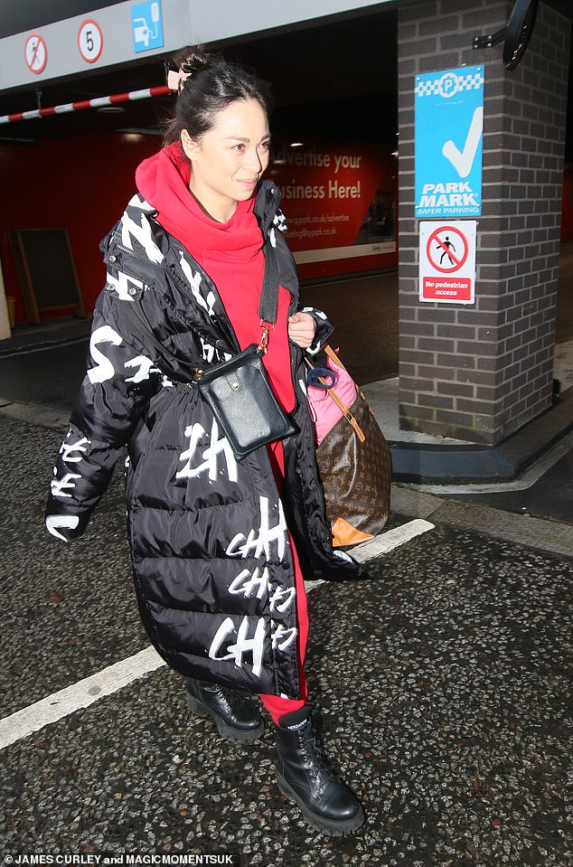 Katya Jones turned heads in a bright red tracksuit that she paired with a padded black jacket and lace-up boots