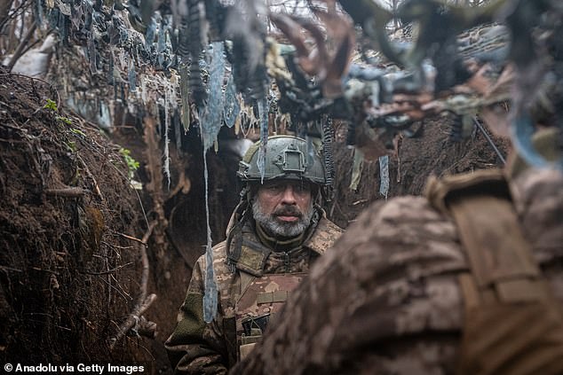 Ukrainian infantrymen stand guard in the trenches on the front line, towards Bakhmut