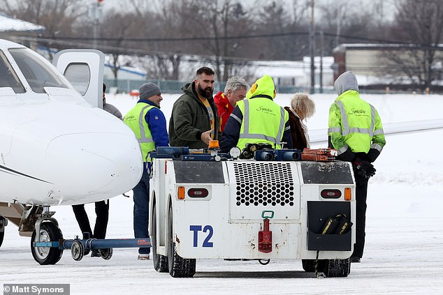 Jason Kelce talks to several employees at the private airport in western New York state