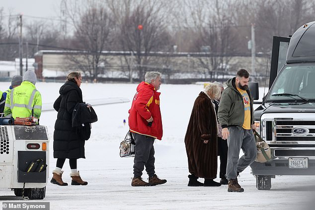 Jason Kelce, wife Kaylie (far left in black) and Ed Kelce walk to the van