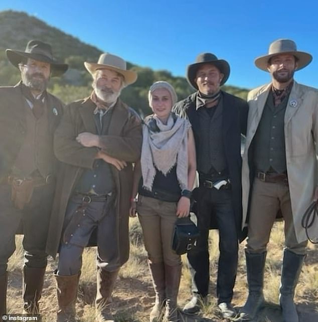 Alec Baldwin and Halyna Hutchins, along with other cast, are pictured on the Rust set in October.  Baldwin and other producers of the film have been ordered by New Mexico safety regulators to pay $136,793 for mistakes that led to the shooting of the cameraman.