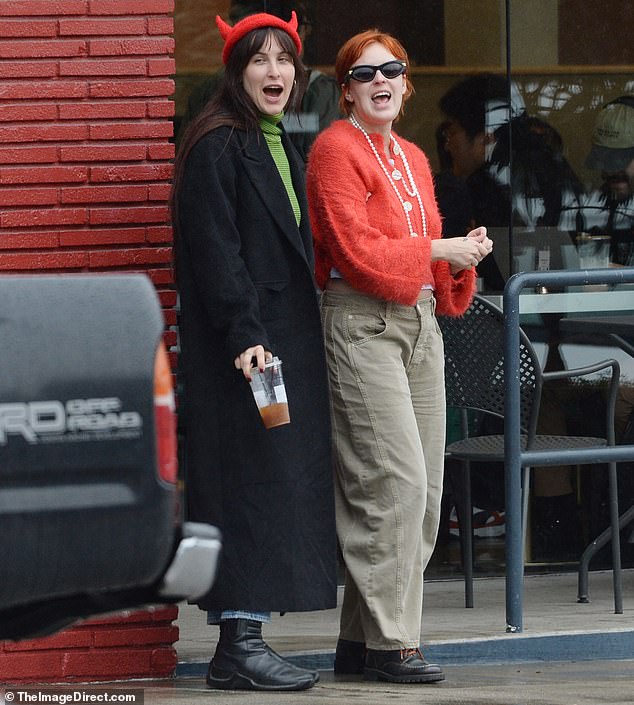 The 61-year-old actress was accompanied by her chihuahua Pilaf as she braved the rain to show her support for her youngest child;  Scout (L) and Tallulah (R) pictured