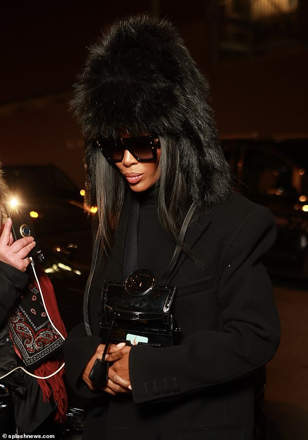 She was later seen wearing a fur hat as she arrived at Costes restaurant in the city after the show