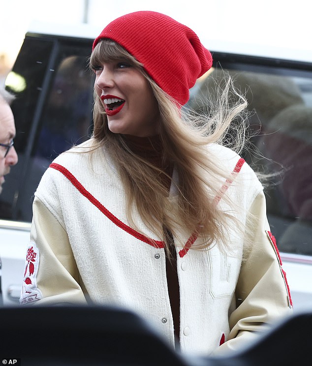 The 34-year-old singer - who attended the match with girlfriend Cara Delevingne - braved the cold in a white and red bomber with a hefty price tag