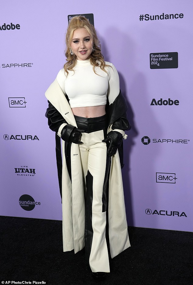 Singer-actor Ella Anderson – best known for Nickelodeon's Henry Danger – showed off her toned stomach in a white cropped turtleneck, which she paired with black and cream leather pants and a duster