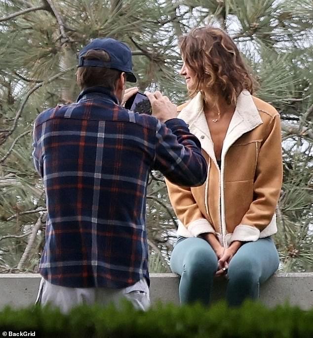 At one point, he was seen taking pictures of his model girlfriend with his phone to document their park date