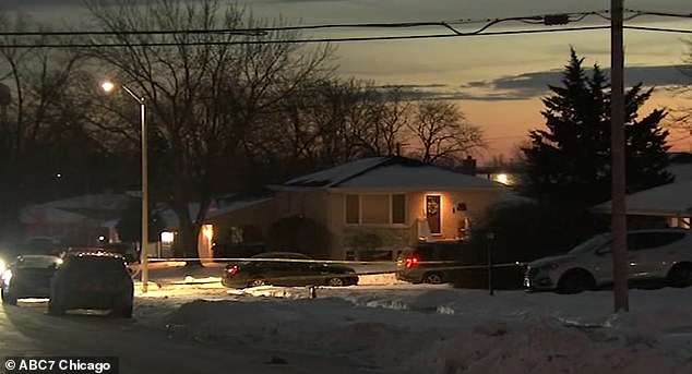 Crime scene tape still surrounded the house at sunset Sunday night