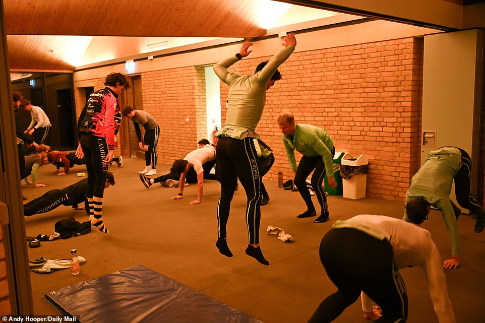 Crews perform a series of stretches and other exercise routines just after 6 a.m. before hitting the water