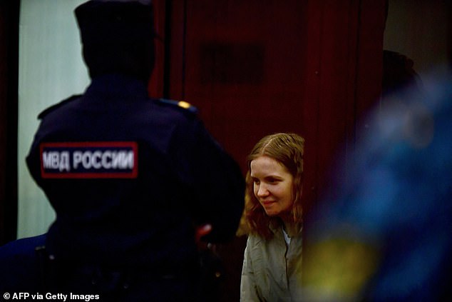 Darya Trepova is pictured in court today in a glass cage as she faces 28 years in prison