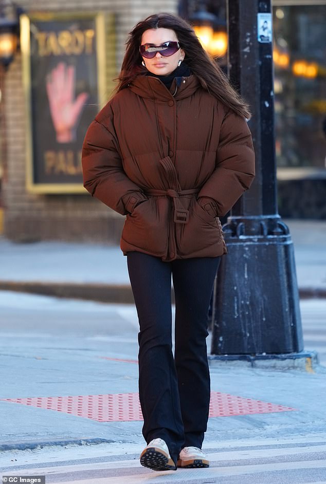 The cover model showed off her tiny waist in a belted brown puffy jacket.  It appeared she was wearing a black turtleneck under the cover-up and black straight leg athleisure pants