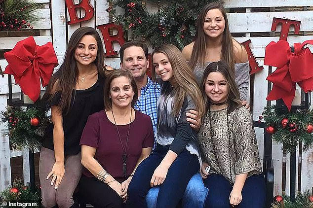 The former gymnast is pictured with her four daughters, Shayla (left), McKenna (top right), Skyla (bottom right) and Emma (center)