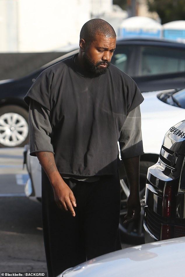 West kept his new smile hidden as he stepped out in black and gray shirts, baggy pants and white slippers