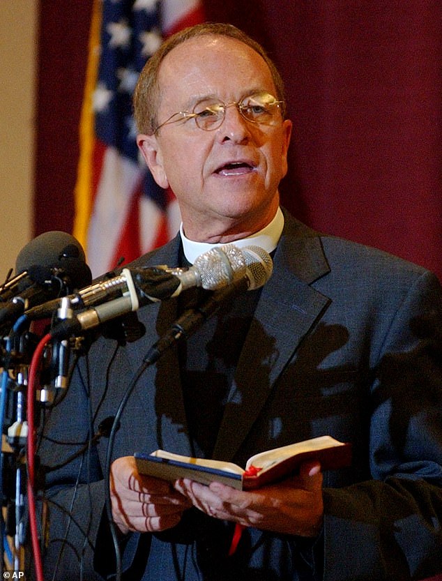 Gene Robinson reads from the Bible at a news conference after the Episcopal Church confirmed him as Bishop of New Hampshire on Tuesday, August 5, 2003 in Minneapolis