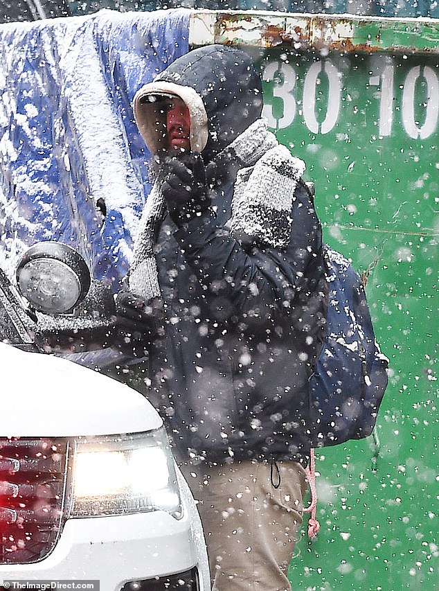 Despite being in the grip of a snowstorm, the man appeared undeterred when approached by an NYPD vehicle.