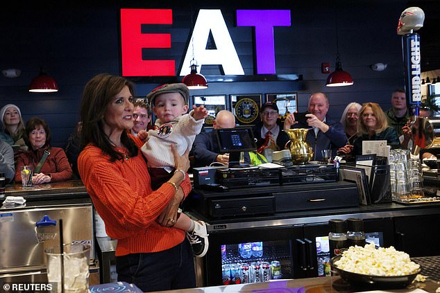 Republican presidential candidate Nikki Haley holds 16-month-old Arthur Colette during a campaign stop at T-Bones ahead of the New Hampshire primary in Concord