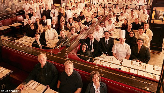 McNally, front center, is seen with his staff and chefs at his Manhattan restaurant, Balthazar