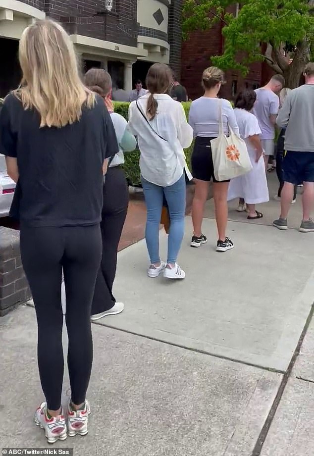 The text from real estate agent Nelson Alexander stated that the rental price had increased from $600 per week to $650 per week due to 'overwhelming demand' (photo: people queuing to view a rental property)