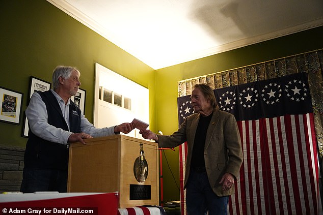 Tom Tillotson returns his ballot after voting in the New Hampshire primary just after midnight on Tuesday, January 23 at the Tillotson House in Dixville Notch