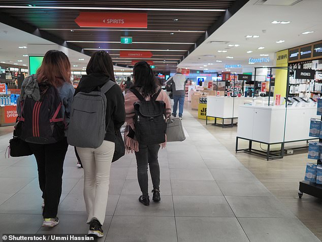 Newcomers to Australia are pictured traveling through Sydney International Airport on September 29, 2023