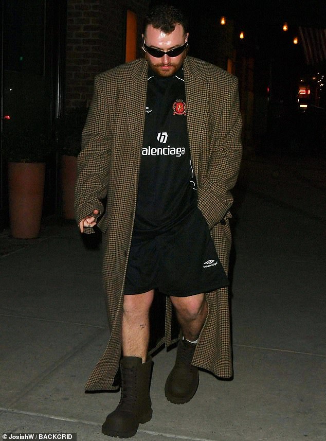 The 31-year-old singer wrapped a long tweed coat over the Balenciaga top, paired shorts with boots and even wore sunglasses at night