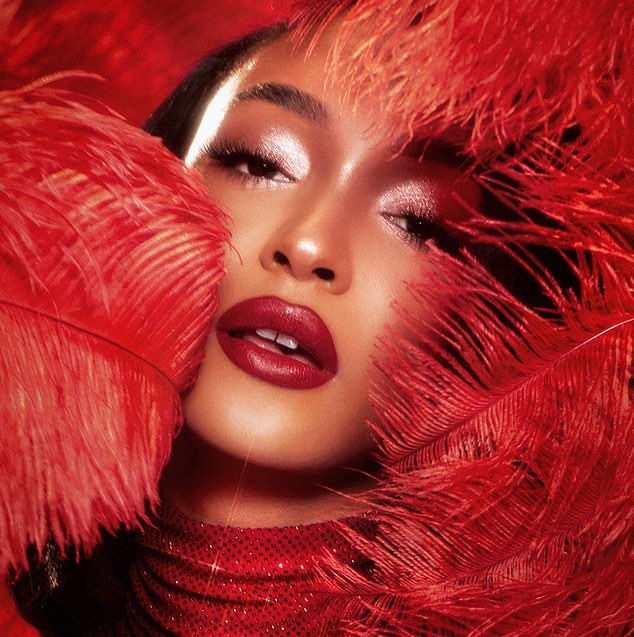 In another shot, she donned a red sequined dress as she posed with feathers