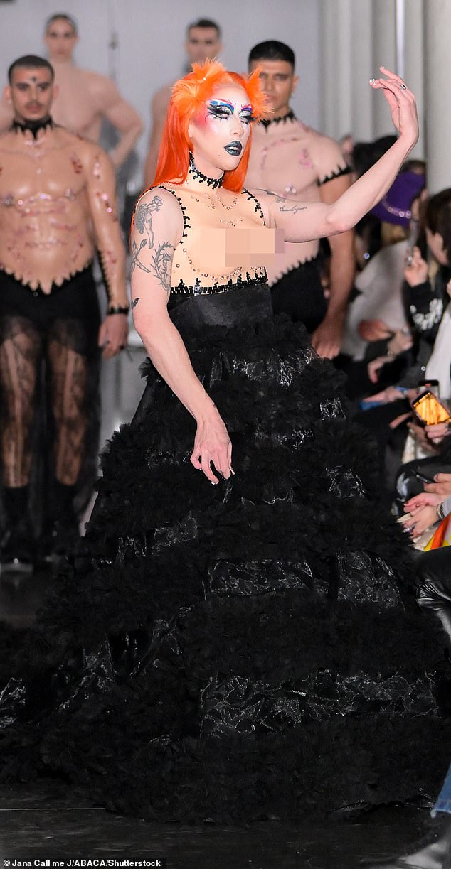 One of the wildest looks featured a model - with bright orange hair and dainty, intense makeup - wearing an elaborate black dress with prosthetic breasts at the bodice