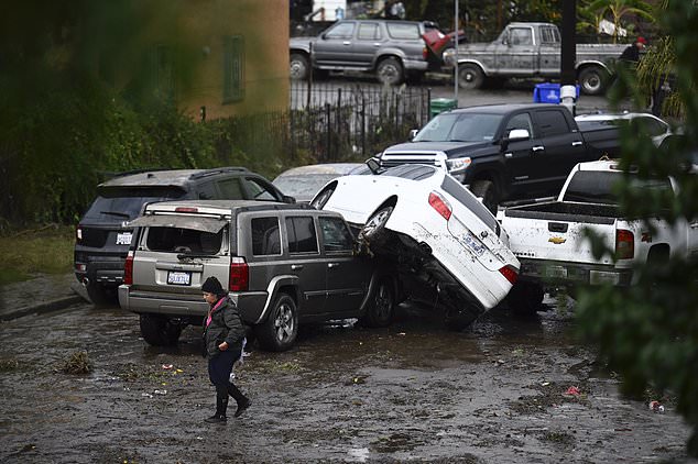 Flooding swept away vehicles and caused cars to pile up on top of each other in parts of San Diego.