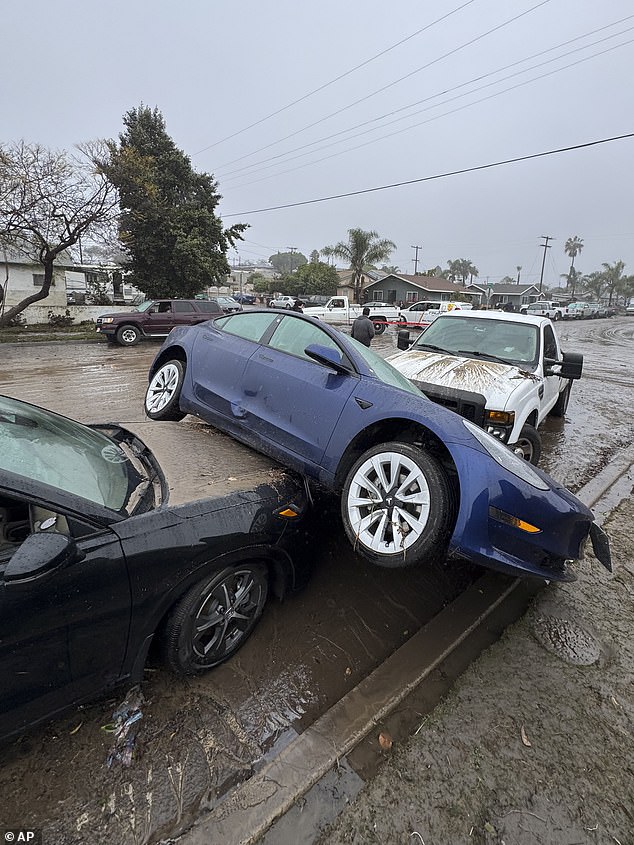 The city fire department said it had rescued at least 24 people from the rushing San Diego and Tijuana rivers