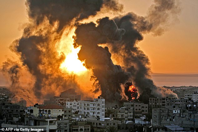 A fire rages in Khan Younis at dawn following an Israeli airstrike on targets in the southern Gaza Strip