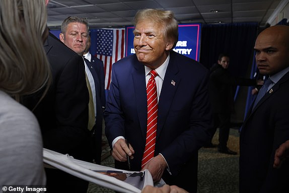 LACONIA, NEW HAMPSHIRE - JANUARY 22: Republican presidential candidate and former President Donald Trump signs autographs and shakes hands with supporters at the end of a campaign rally in the basement ballroom of The Margate Resort on January 22, 2024 in Laconia, New Hampshire.  Ramaswamy, Burgum and Scott all fought Trump for the Republican presidential nomination, but later dropped out and endorsed him.  Trump is rallying supporters the day before New Hampshire voters weigh in on the Republican nomination race with the nation's first primaries.  (Photo by Chip Somodevilla/Getty Images) *** BESTPIX ***