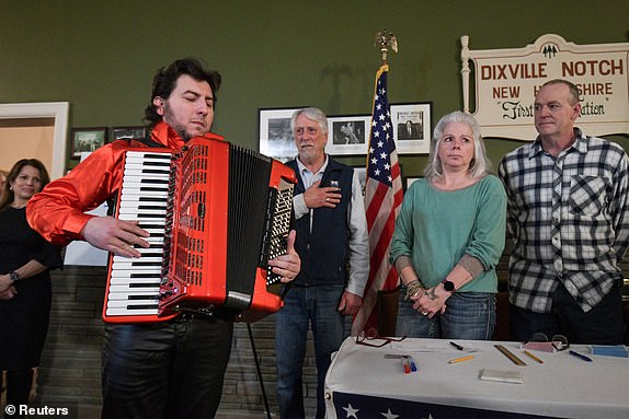 Cory Pesaturo plays the national anthem on accordion to begin voting after midnight on U.S. presidential election day in the living room of the Tillotson House at the Balsams Hotel in Dixville Notch, New Hampshire, U.S., January 23, 2024. REUTERS/Faith Ninivaggi