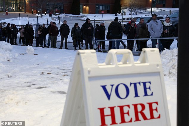 New Hampshire residents brave the cold morning to line up in Derry to vote in New Hampshire's Republican primary