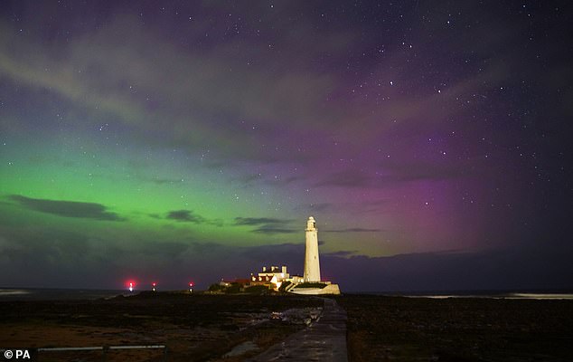 The Northern Lights (aurora borealis) above St Mary's Lighthouse in Whitley Bay on the northeast coast of England.  Photo date: April 24, 2023