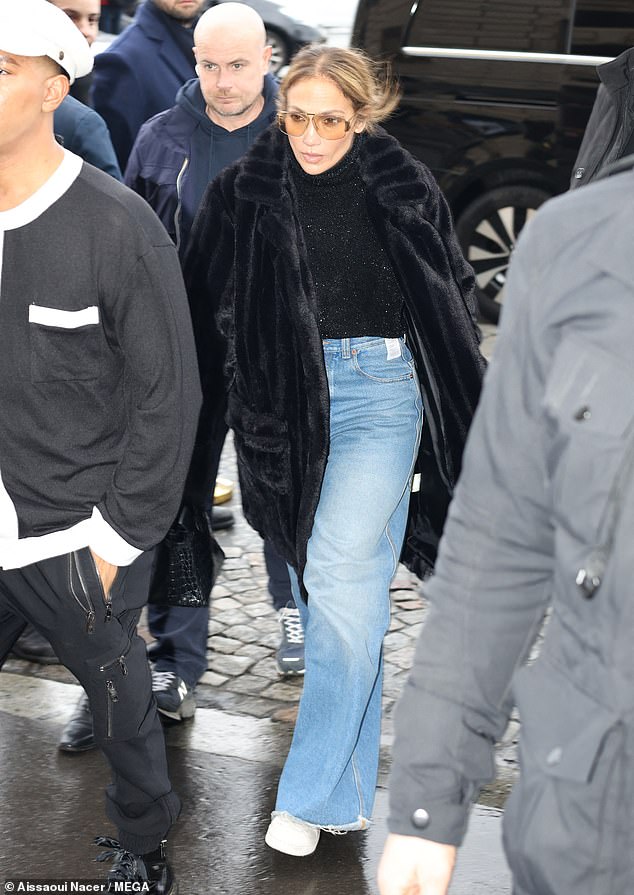 The 54-year-old singer looked stunning as she tucked a sparkly black sweater into oversized blue wide-leg jeans