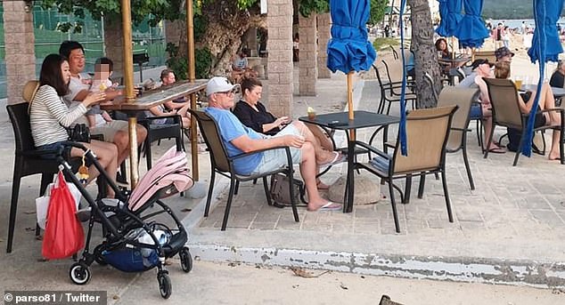 Scott Morrison is pictured (center, wearing a blue T-shirt) on vacation in Hawaii while Australia was in a bushfire crisis