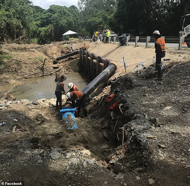 Heavy rain, already brought by the tropical low system, caused water outages in Port Douglas on Monday (photo, repair crews)