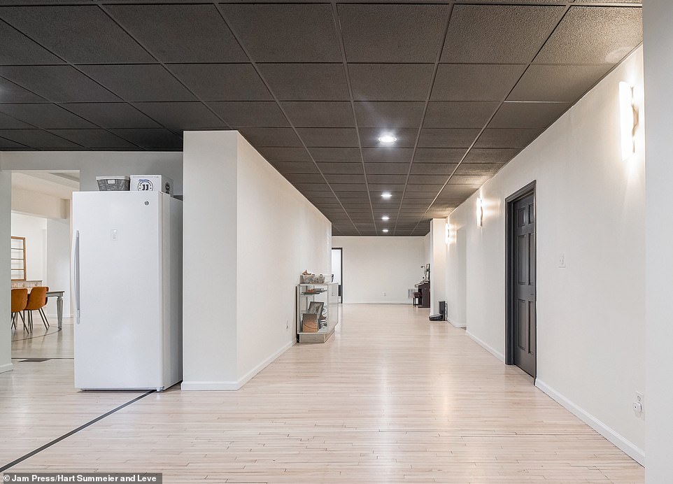 The entrance leads directly to the kitchen, which was built on top of the former basketball court and still has the original black lines painted across the floor