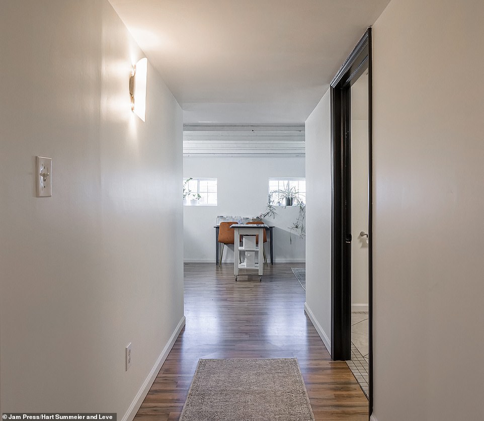 The hallway is lined with mirrors, lamps and side tables and takes you to the three bedrooms