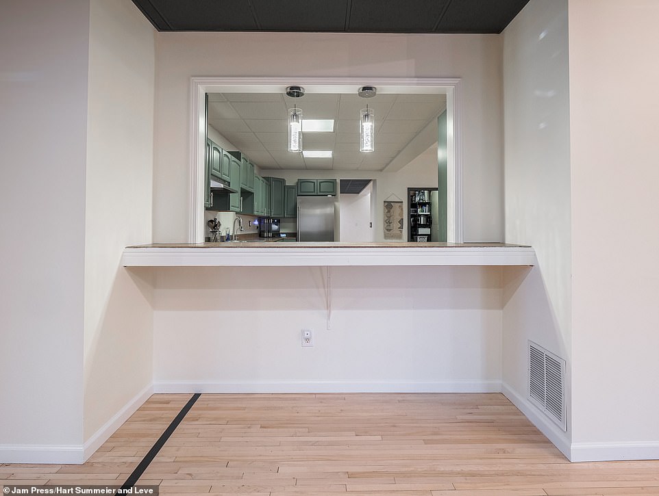 The expansive kitchen also features a window that provides bar seating for owners who want to add sleek bar stools