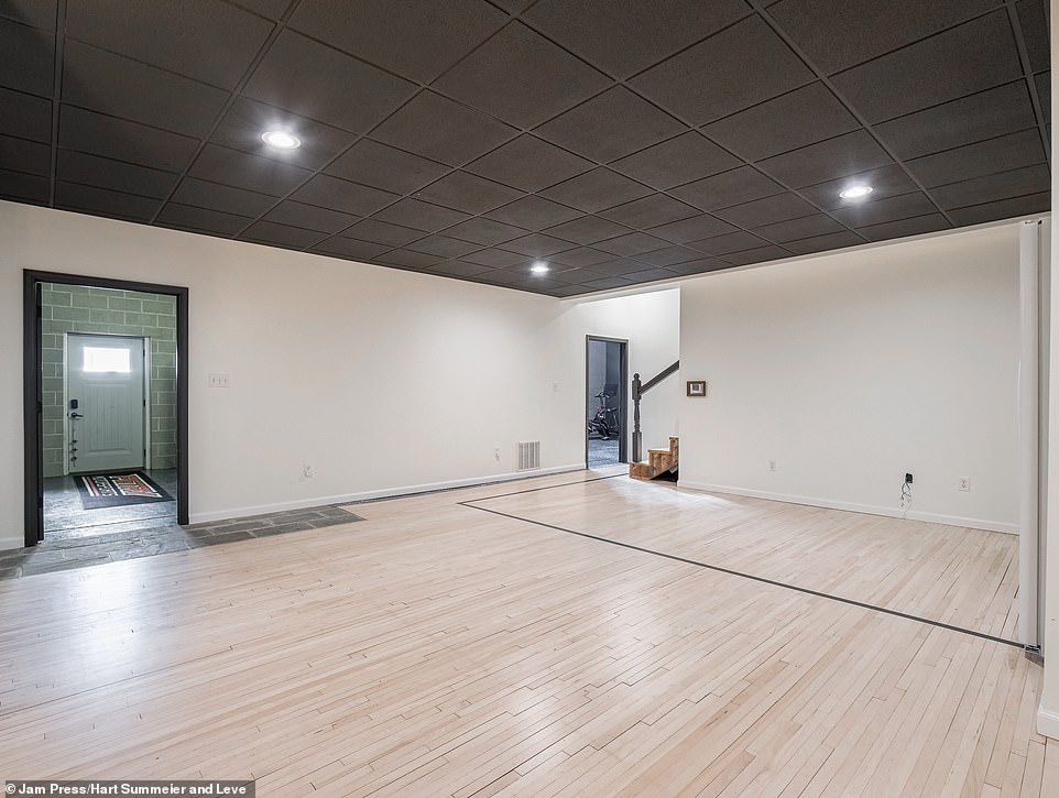 The sleek and light-colored wooden floor panels continue into the hallways of the entire building