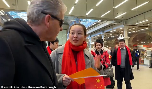 The woman (pictured) said she worked for Chinese TV and asked him to stop filming their group